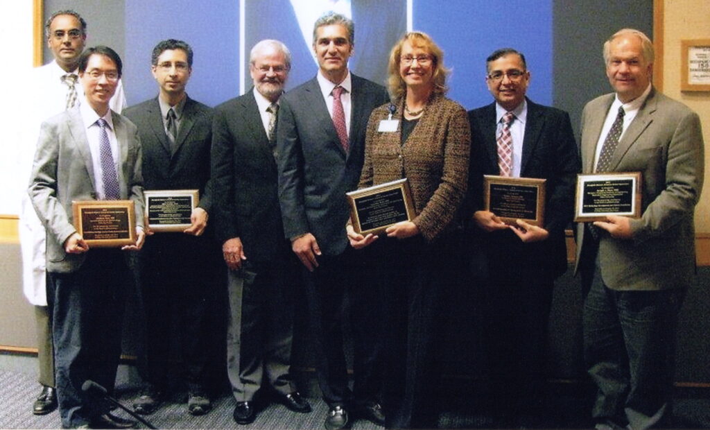Members of the Duke Eye Center and Departments of Bioengineering at the K. Alex Dastgheib Pioneer Award in 2014. Pictured: Anthony Kuo, M.D. (Award Recipient), Sina Farsiu, Ph.D. (Award Recipient), Cynthia Toth, M.D. (Award Recipient), Sanjay Asrani, M.D. (Award Recipient), Joseph Izatt, Ph.D. (Award Recipient), Dr. Anthony Kuo. The recipients pioneered clinical applications of optical coherence tomography (OCT) imaging in surgery and at the bedside.
